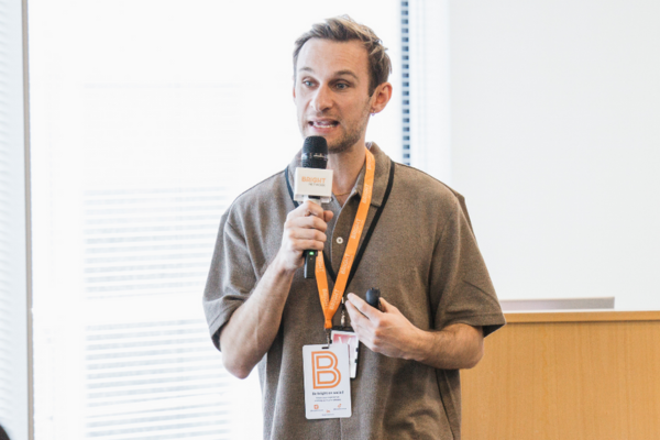 Ally from Bright Network delivering a talk with a microphone
