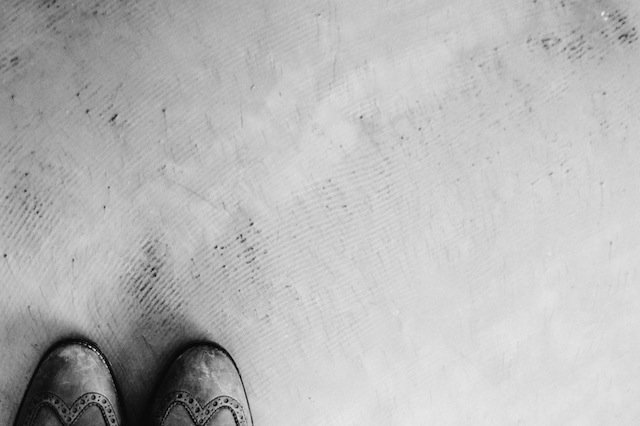 A pair of grey shoes on a concrete floor