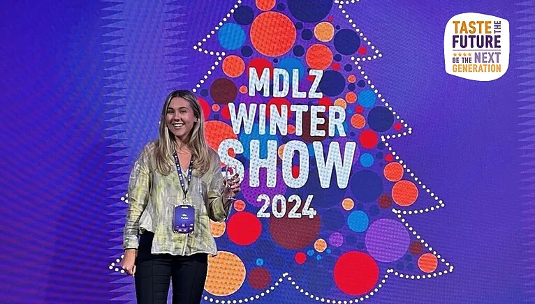 Image of Ella smiling in front of a screen for "MDLZ Winter Show 2024"