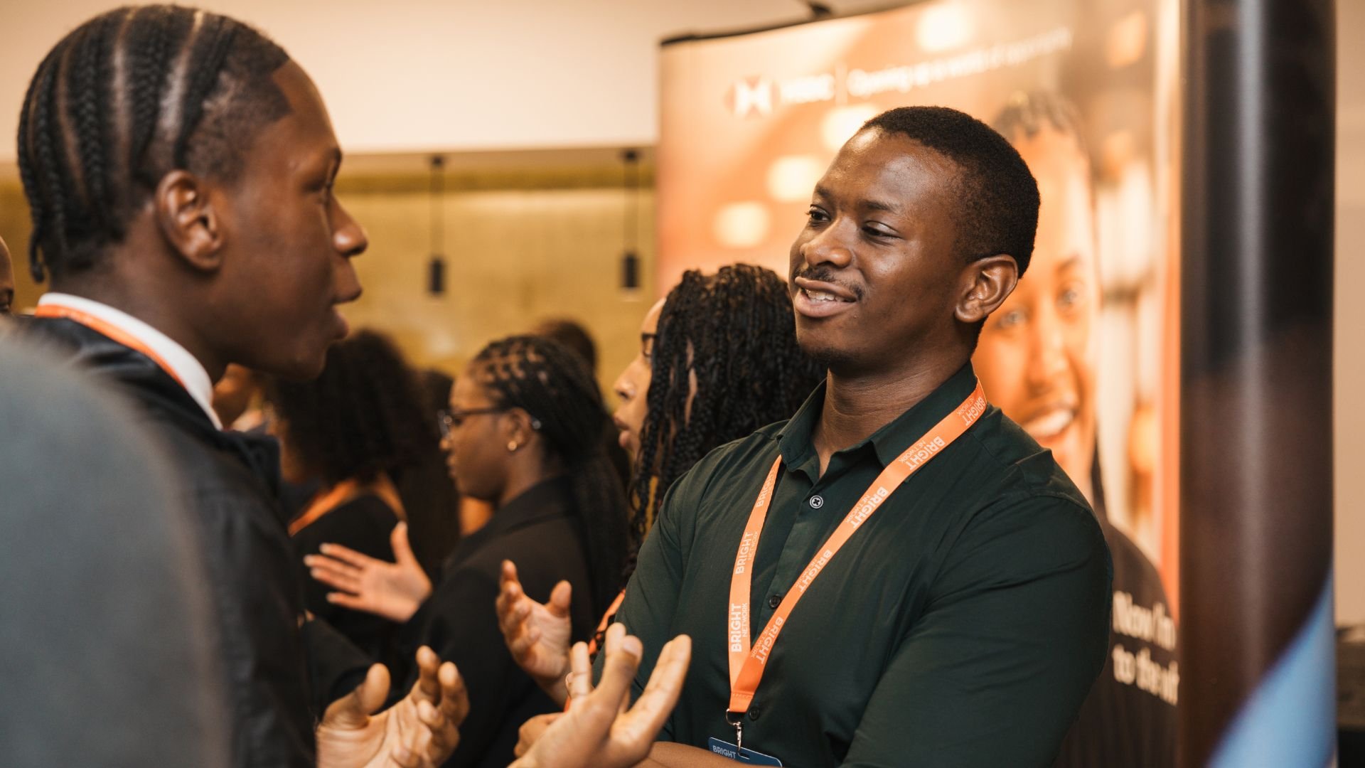A photo of a student at Black Heritage Future Leaders 2025 talking to an employer. They are smiling and in conversation.