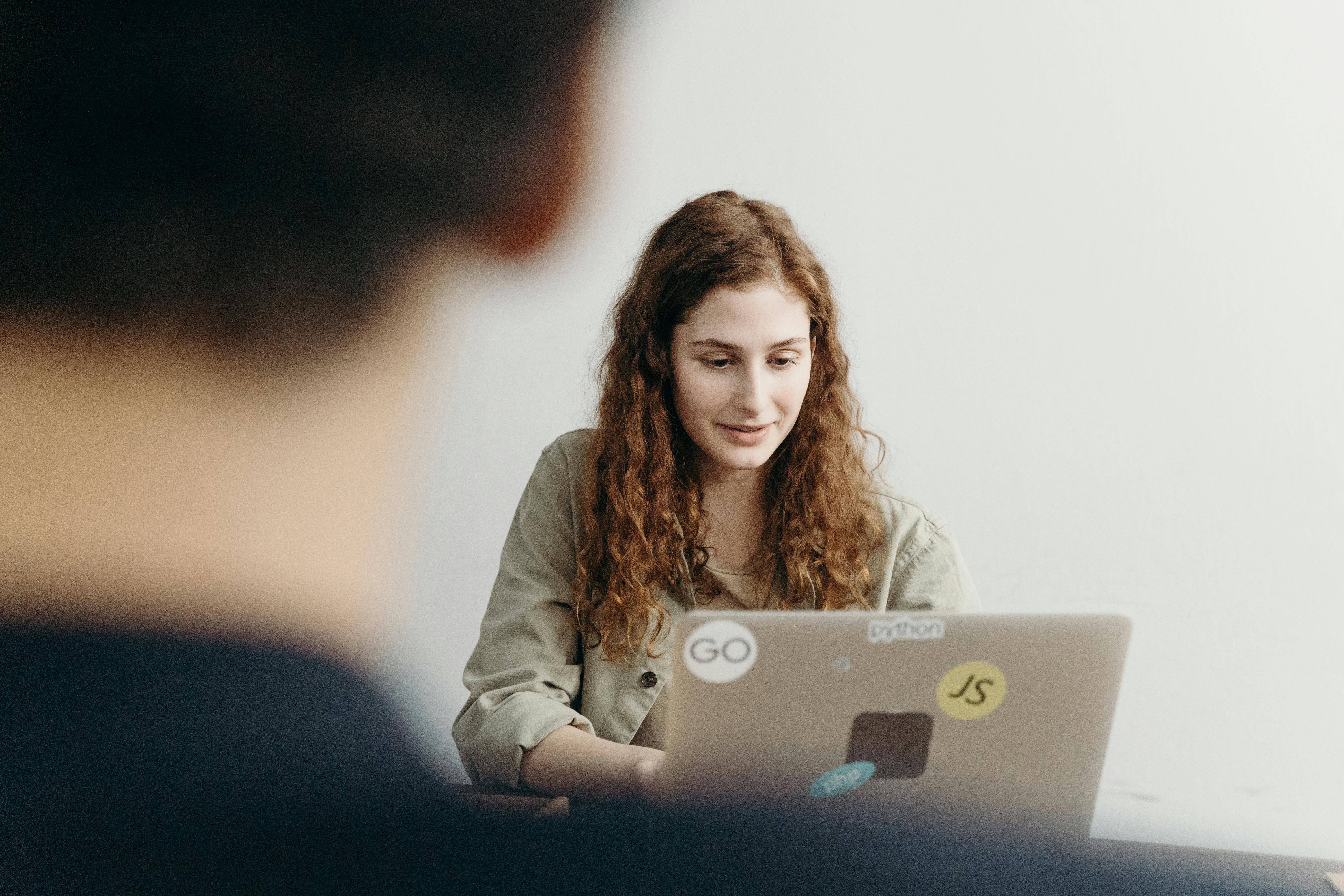 Woman using a laptop.