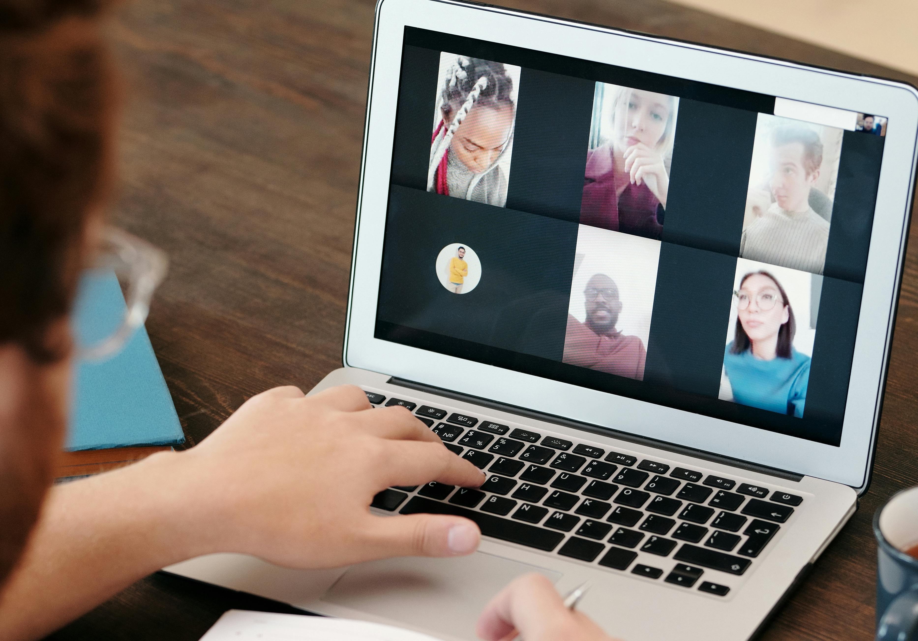 A laptop showing people on a conference call