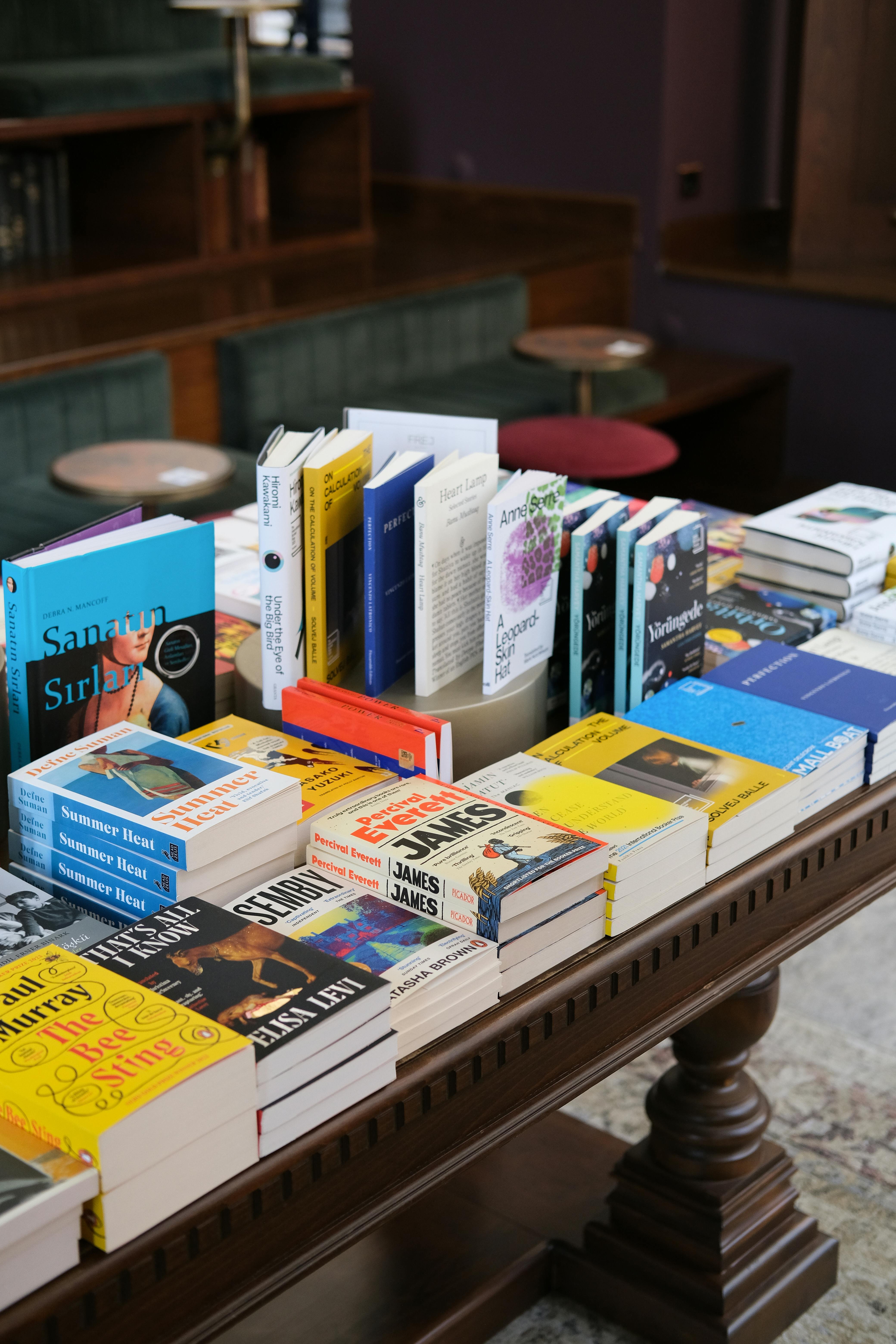 A stack of new books on a table in a bookshop