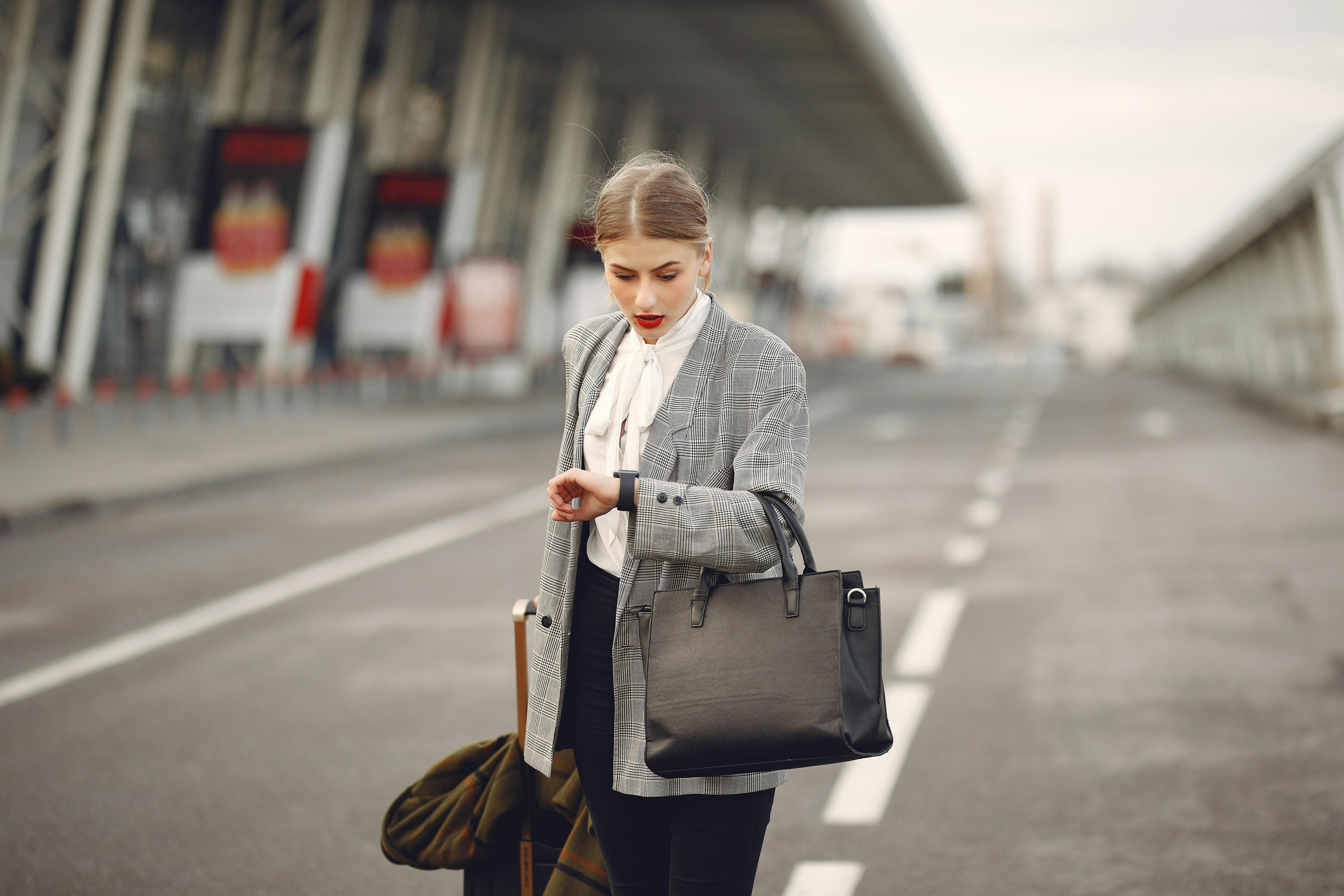 Smartly dressed woman checking the time on her watch