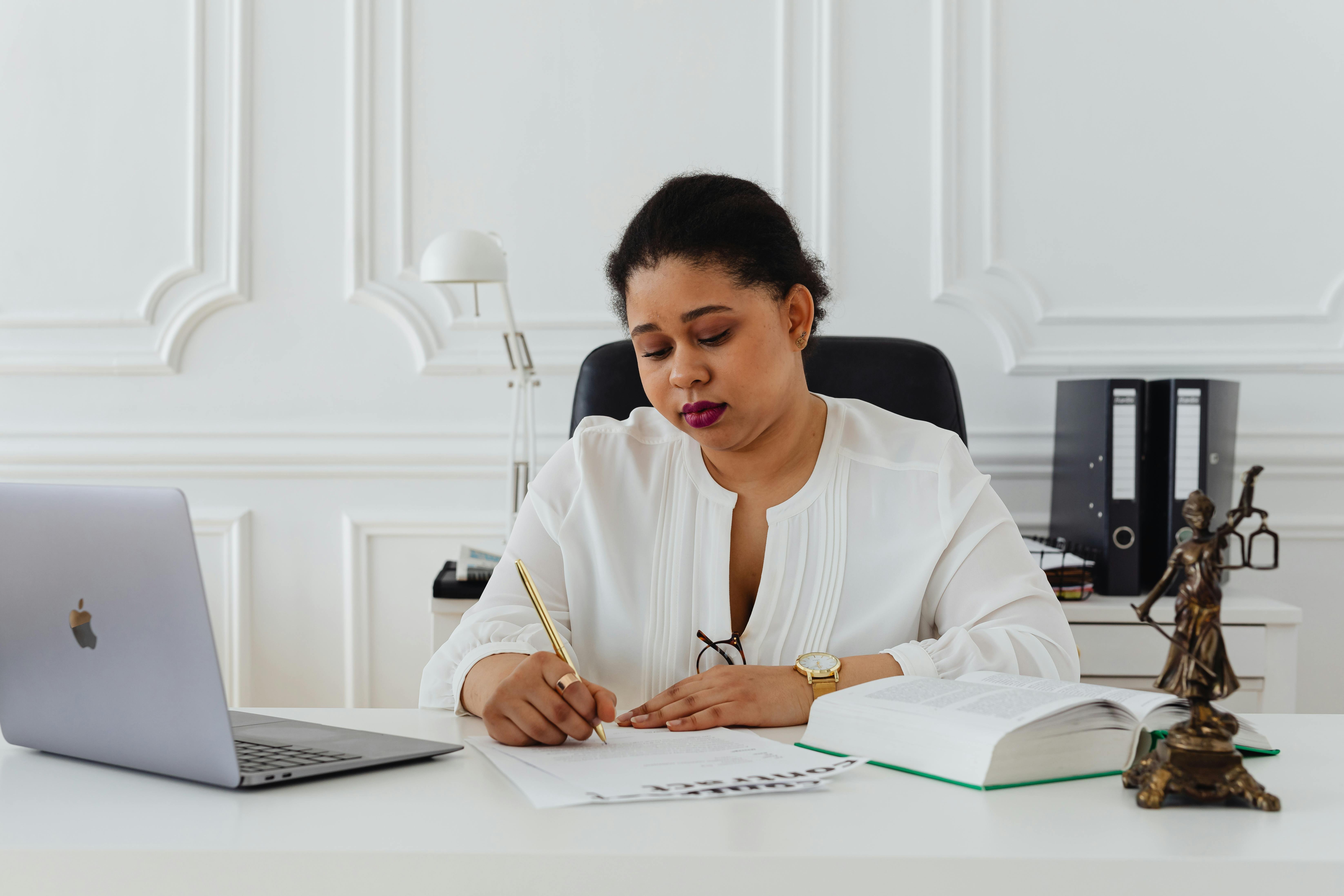 Woman working on a desk in a law office.