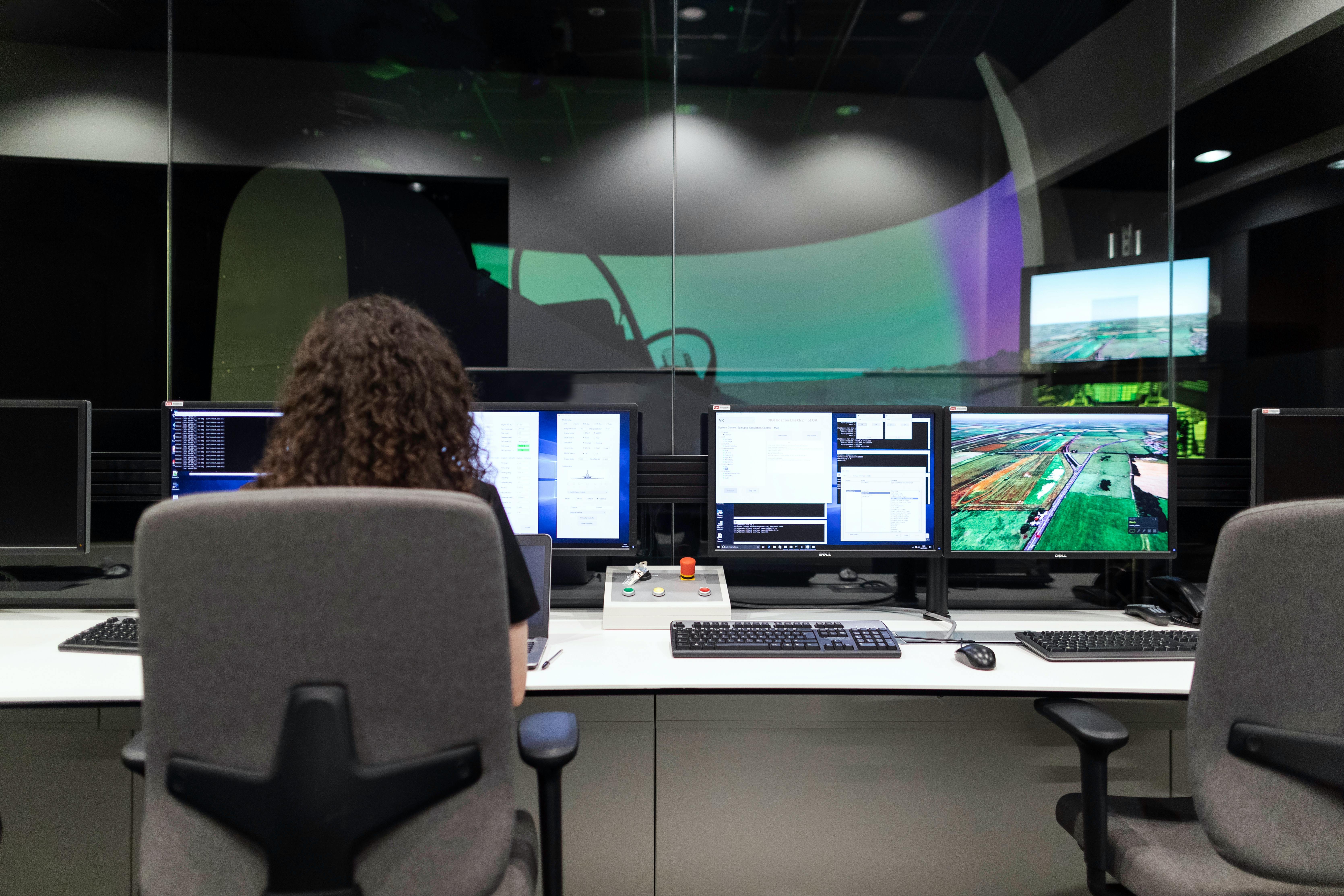 Female engineer controlling flight simulator.